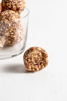 a glass bowl filled with oatmeal and raisins on top of a white table