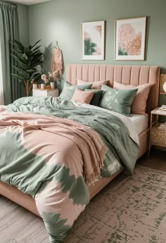 a bedroom with green walls and pink bedding in the center, two pictures on the wall