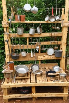 an outdoor pot rack with pots and pans on it