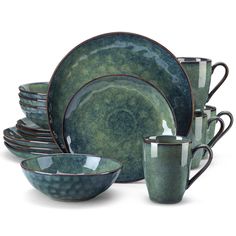 a set of green dishes with cups and saucers