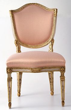 an antique chair with gold trim and pink upholstered seat, against a white background