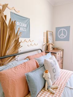 a bed room with a neatly made bed and a peace sign on the wall above it