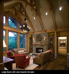 a living room filled with furniture and a fire place in the middle of a room