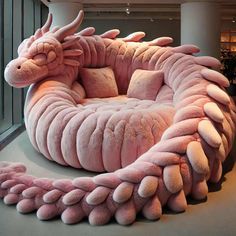 a large pink dragon chair sitting in the middle of a room