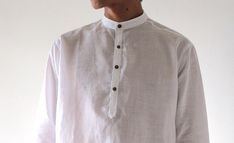 "Long-sleeved slim fit djellaba style men's shirt Round neck without collar, finished with stitches details on the cuffs and with 4 buttons on the front. Comfortable material : 100% Linen Gorgeous and smooth touch. Casual but chic even for semi formal occasions. Available in 4 colors. Please selct the color from the swatch. Size S/M Fit for (US 36\"-40\" EU 38-40) Chest42\" Shoulder 20\" Sleeve Length23\" Length31\" Size L/XL Fit for (US 36\"-40\" EU 38-40)US 44\"-50\"50\" EU 42-50 ) Chest54\" S Shirt With Buttons, Linen Men, Collar Shirt, Polo Collar, 50 50, Collar Shirts, Formal Occasion, Men's Polo, Semi Formal