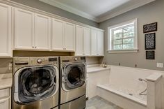 a white laundry room with washer and dryer