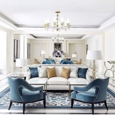 a living room filled with lots of white furniture