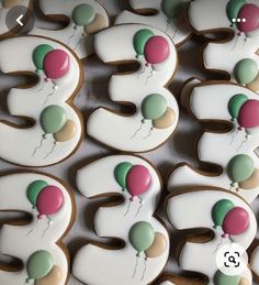 decorated cookies in the shape of numbers with balloons