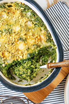 a casserole dish with broccoli, cheese and bread crumbs