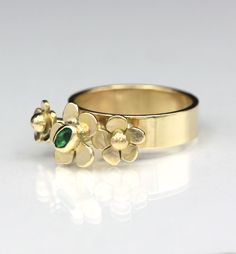 D E T A I L S :Emerald Garden Flower Ring, One of a kind ringGemstones: .13 ct Natural Zambian Emerald Metal: 14K solid yellow goldBand Width: 5mmSize: US 7One of a kind Art JewelryHandmade by Jen in the USA ______________ FINE JEWELRY THAT IS ONE OF A KIND - JUST LIKE YOU: This is the newest addition to the Flower Garden and I call it “The Emerald Garden”. This one of a kind ring is designed in full 3 dimension and the flowers stand up as if they’re growing toward the sun. the eye clean Zambian Yellow Gold Flower Promise Ring For May Birthstone, Yellow Gold Flower Jewelry For May Birthstone, Anniversary Yellow Gold Flower Ring With May Birthstone, Flower-shaped May Birthstone Rings For Wedding, Flower Shaped Ring With May Birthstone For Wedding, Flower Shaped May Birthstone Rings For Wedding, Flower-shaped May Birthstone Wedding Rings, Green Flower-shaped Emerald Ring For Anniversary, Anniversary Emerald Flower Ring In Green