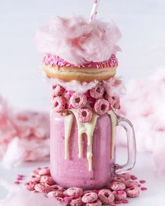 a pink drink with donuts and sprinkles on top