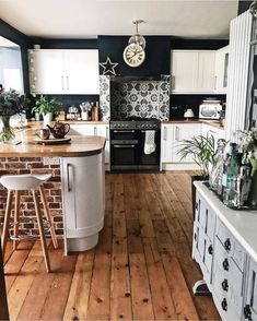 a kitchen with white cabinets and wood floors is featured in the instagram post, which reads explore best interior - follow