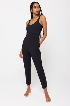 A fitted, ankle-length jumpsuit. Designed with side slant pockets and an interior shelf bra. This mid-weight jersey material feels like you're wearing nothing. We’ve brushed the inside so it's extra soft against the skin. It’s moisture wicking breathable making this the perfect active material that will allow movement and comfort, on and off the mat. | Maggie Active Bodysuit in Black Athleisure Jumpsuits And Rompers For Loungewear, Athleisure Loungewear Jumpsuits And Rompers, Sporty Elastane Jumpsuits And Rompers For Loungewear, Sporty Elastane Jumpsuit For Loungewear, Fitted Solid Jumpsuits And Rompers With Side Pockets, Black Athleisure Jumpsuits And Rompers With Built-in Bra, Stretch Jumpsuits And Rompers With Side Pockets, Sporty Jumpsuits And Rompers With Built-in Bra, Active Bodysuit