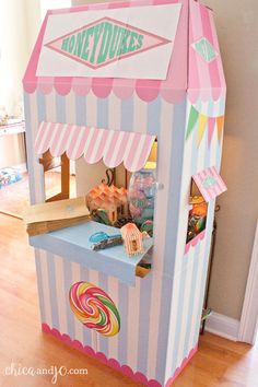 a pink and white striped candy machine on the floor