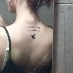 a woman with a bird tattoo on her back