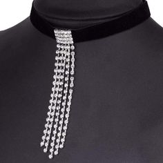 This choker is sure to be a favorite. A black choker is center adorned with a cube of clustered rhinestones then dramatically fashioned with five independent strands of dangling rhinestones. Lost of movement means lots of sparkle. Choker is approximately 12.2" around with an adjustable clasp closure that adds approximately up to 2". Center embellishments measure 3.75" at longest point. Metal Rhinestone Choker Necklace, Evening Rhinestone Choker Necklace, Black Rhinestone Party Choker, Party Black Choker With Rhinestones, Party Black Rhinestone Choker, Adjustable Black Rhinestone Necklace For Party, Evening Rhinestone Metal Choker Necklace, Glamorous Adjustable Rhinestone Choker Necklace, Glamorous Adjustable Choker For Evening