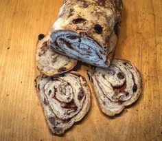 several pieces of bread sitting on top of a wooden table