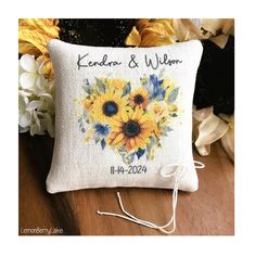 a cross stitch pillow with sunflowers and the words kendon & willow on it