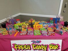 the fresh candy bar is set up with pink table cloth