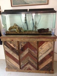 a fish tank sitting on top of a wooden cabinet