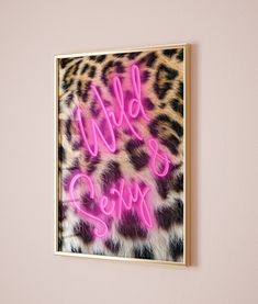 a pink neon sign on a wall above a leopard print