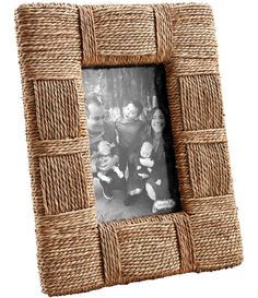 a wicker photo frame with an image of two people and one child in it