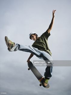 a skateboarder is doing a trick in the air with his board stock photo