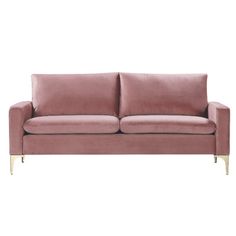 a pink velvet couch with gold legs