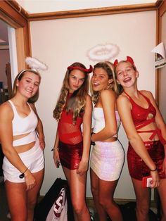 four young women dressed in costumes posing for the camera