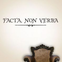 a chair sitting in front of a wall with the words facta non verbba on it