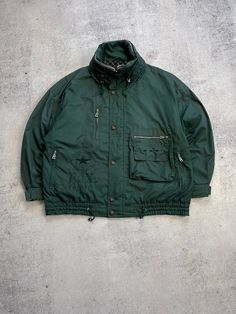 This Bogner Expedition Vintage Men's Green Jacket is a must-have for any ski or outdoor enthusiast. Made with high-quality polyester material, this mid-length jacket features a full zip closure and zipped pockets for your convenience. The oversized jacket is hooded and comes in a retro 90s style, perfect for all seasons. The green jacket is a size 52 and has a regular fit, making it suitable for most men. The jacket is made in Italy and is perfect for winter and fall seasons. The jacket's features include all-season suitability, making it a great investment for any outdoor activity. Size 52 (see measurements) The length of the sleeve from the neck is 80 cm From shoulder to shoulder - 65 cm The length of the back is 73 cm Condition 8/10  See all photos and read description.   If you need an Nylon Parka With Zipper Closure For Outdoor, Functional Parka With Zipper Closure For Outdoor, Functional Outdoor Parka With Zipper Closure, Winter Sports Nylon Parka With Pockets, Nylon Parka With Pockets For Winter Sports, Winter Outdoor Track Jacket With Zipper Closure, Winter Outdoor Track Jacket With Zipper, Utility Outerwear With Ykk Zipper For Outdoor Activities, Winter Track Jacket With Zipper Closure For Outdoor