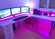 a computer desk with three monitors on it