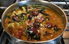 a pot filled with lots of food on top of a stove