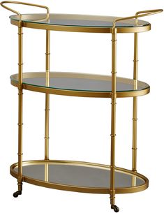 a three tiered gold metal shelf with glass shelves