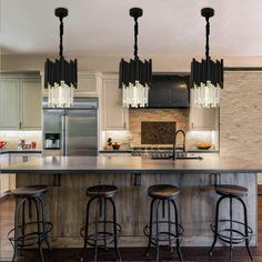 a kitchen island with four stools in front of it