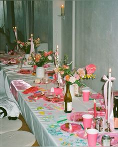 a long table with pink and white decorations