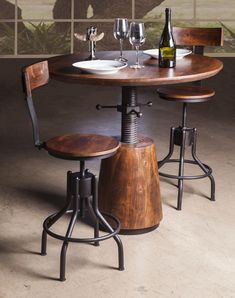 two wooden stools sitting at a table with wine glasses on it