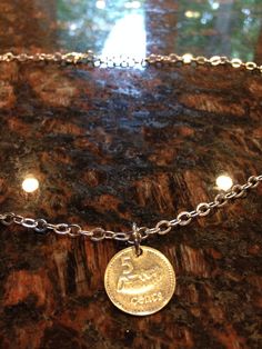 This is a necklace made with a Fiji 5 cents coin. It comes with an 18 inch silver plated chain and has a lobster clasp. If you would prefer to have this coin on a bracelet please let us know as we can do that. Depending in the availability of the coins we can do bracelets, earrings, necklaces and pendants for most any of the coins we have listed for sale on here. We do not clean any coins and we polish very, very few as we want to leave all of the character on each coin. Each coin tells its own Cut Coin Jewelry, Coin Anklet, Coin Belt, Unique Bangle, Wire Bangle Bracelets, Wire Wrapped Bangles, Coin Bracelet, 5 Cents, Wire Bangles