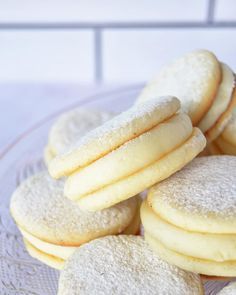 a plate full of sugar cookies on top of a white tablecloth covered countertop