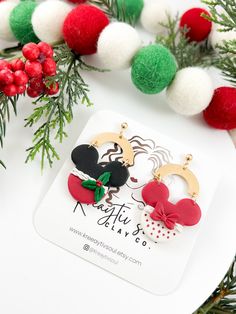 the minnie mouse earring is next to some christmas decorations