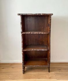 an old wooden book shelf on the floor