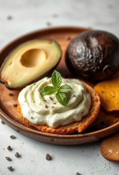 an avocado and some bread on a plate with other food items around it