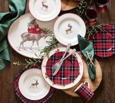 a table topped with plates covered in christmas decorations