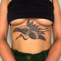 a woman with a bird tattoo on her stomach