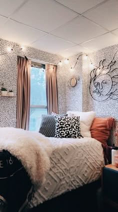 a bedroom decorated in black, white and orange with lights on the wall above the bed