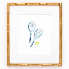 two tennis racquets and a ball on a white background in a bamboo frame