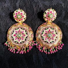 Gold plated chandbali earrings in 92.5 silver. The setting stones are synthetic rubies and emeralds. All pearls used are real freshwater pearls. The hanging beads are real rubies and emeralds. Weight - 65 GMs Height - 9.25 cms Width - 5.25 cms Festive Jeweled Temple Jewelry Chandbalis, Festive Jeweled Chandbali Pearl Earrings, Festive Stone Work Beaded Earrings, Jeweled Temple Jewelry Bridal Earrings For Diwali, Diwali Temple Jewelry Style Bridal Earrings, Diwali Temple Jewelry Bridal Earrings With Jewels, Temple Jewelry Jeweled Danglers For Festivals, Temple Jewelry Style Jeweled Danglers For Festivals, Jeweled Temple Jewelry Danglers For Festivals