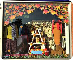 a window display with colorful clothing and decorations