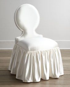 a white chair sitting on top of a hard wood floor