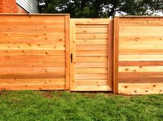 a wooden fence that is in the grass